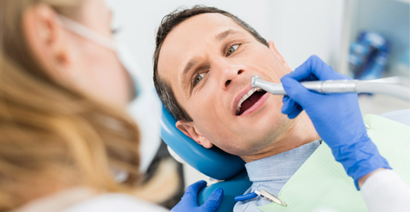 Dental office patient and dentist benefitting from dental claims automation