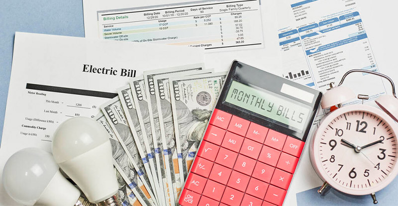 Utility bills and calculator showing the importance of streamlined utility bill processing