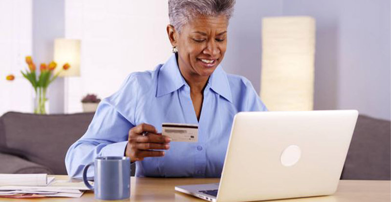 Woman working on computer exploring benefits of modern payment processing