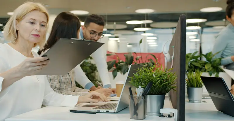 A finance team reviewing documents on screens in a modern office